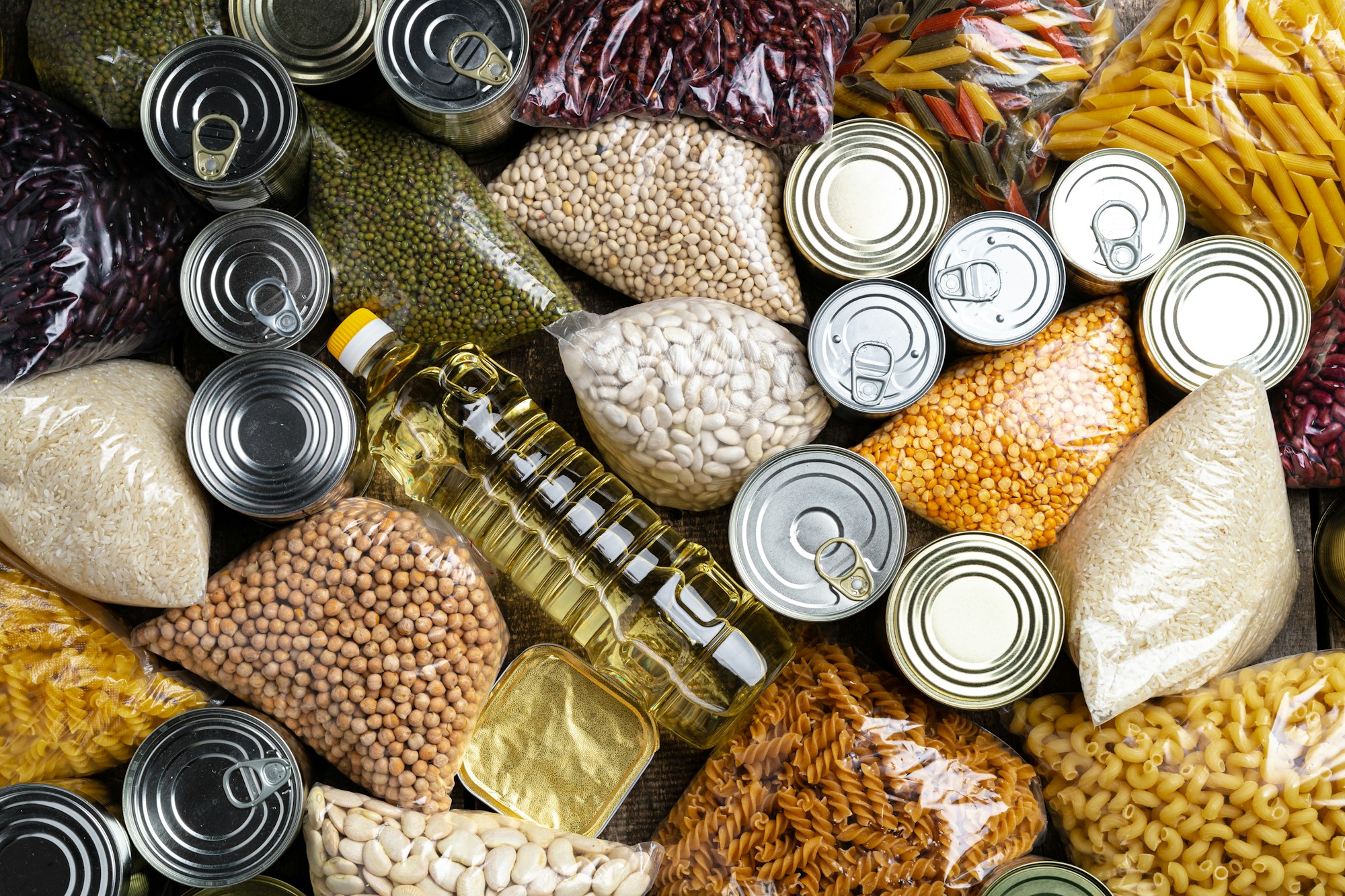 Donations food with canned food on the table background. Donate concept